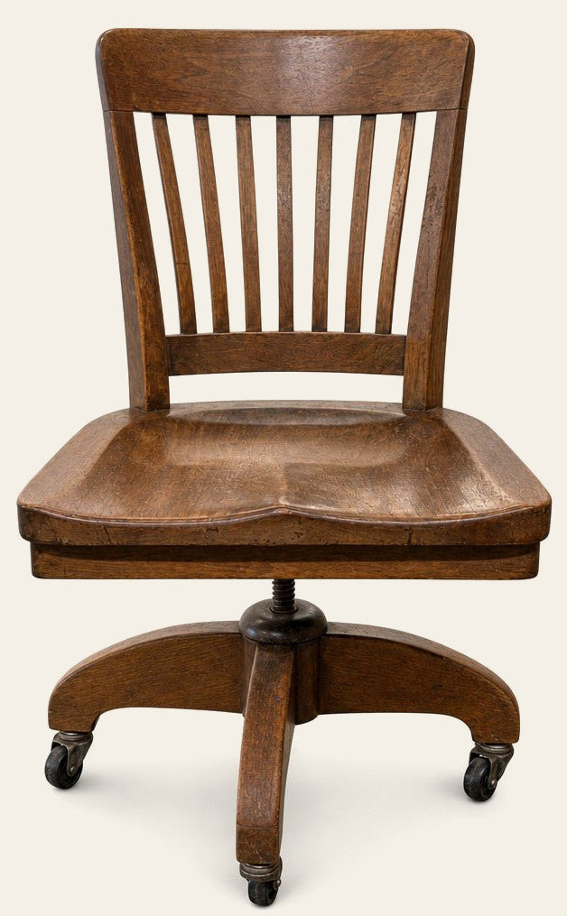 Medium oak brown vintage bankers chair with spindle back and saddle seat by Heywood - Whats New Furniture Portland OR