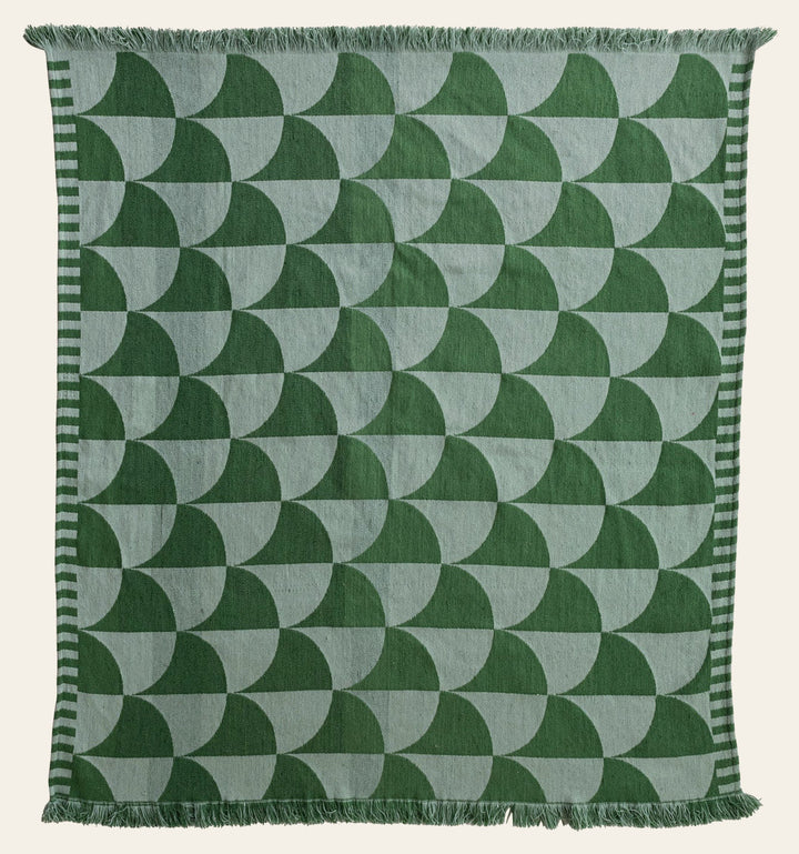 Woven Indoor Outdoor Throw with green scalloped fan pattern and fringe laid flat - outdoor throw by Creative Co-Op - Whats New Furniture Portland OR