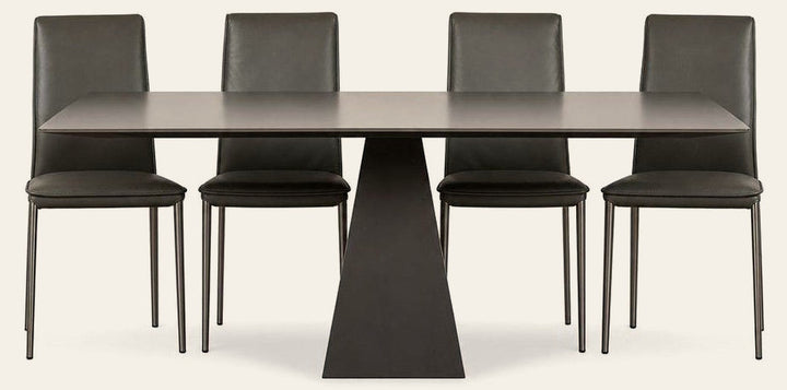 Gray Gunnar dining table with a long tempered glass top and mid-century frame.