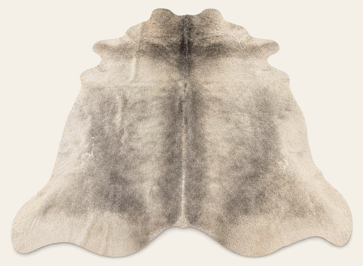 Gray Beige cow hide area rug with irregular natural hide markings.