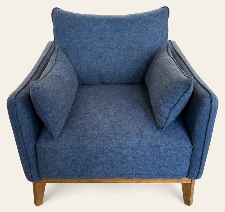 Medium Blue mid-century armchair with a boxy upholstered seat and wood frame.