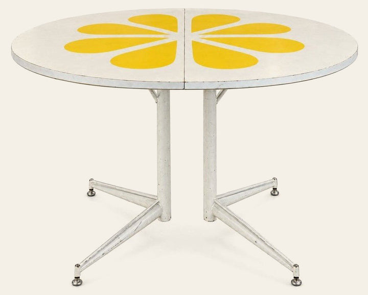 White / Yellow mid-century dining table with a two-tone laminate top and tapered legs.