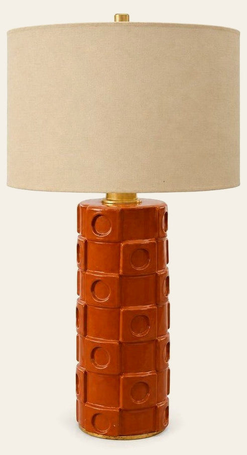 Burnt orange ceramic table lamp with a tapered mid-century body.