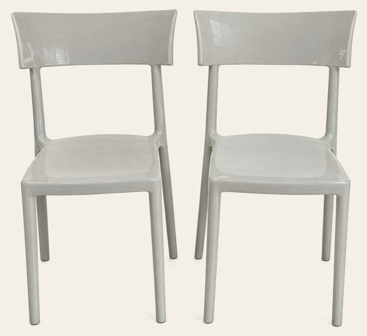 Light gray dining chairs with a single molded Catwalk shell by Kartell