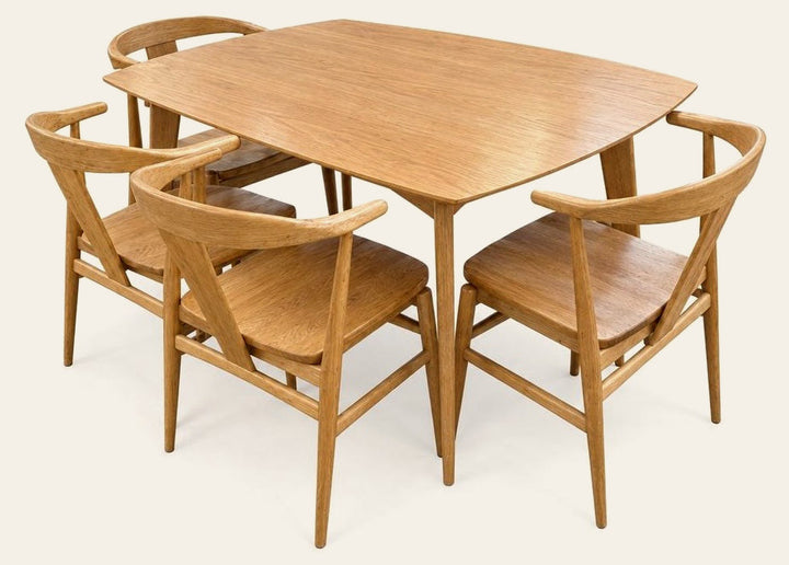 Natural Oak dining table and four chairs with a rectangular wood top.