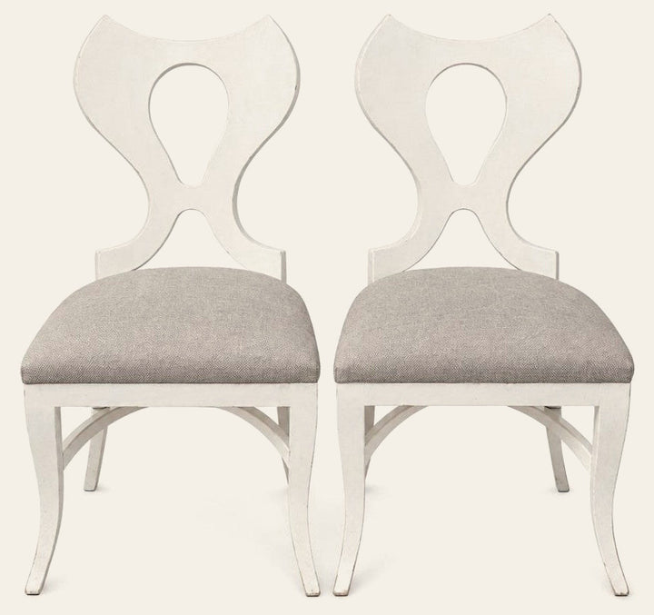 White dining chairs sold as a matching set of two with clean contemporary lines.