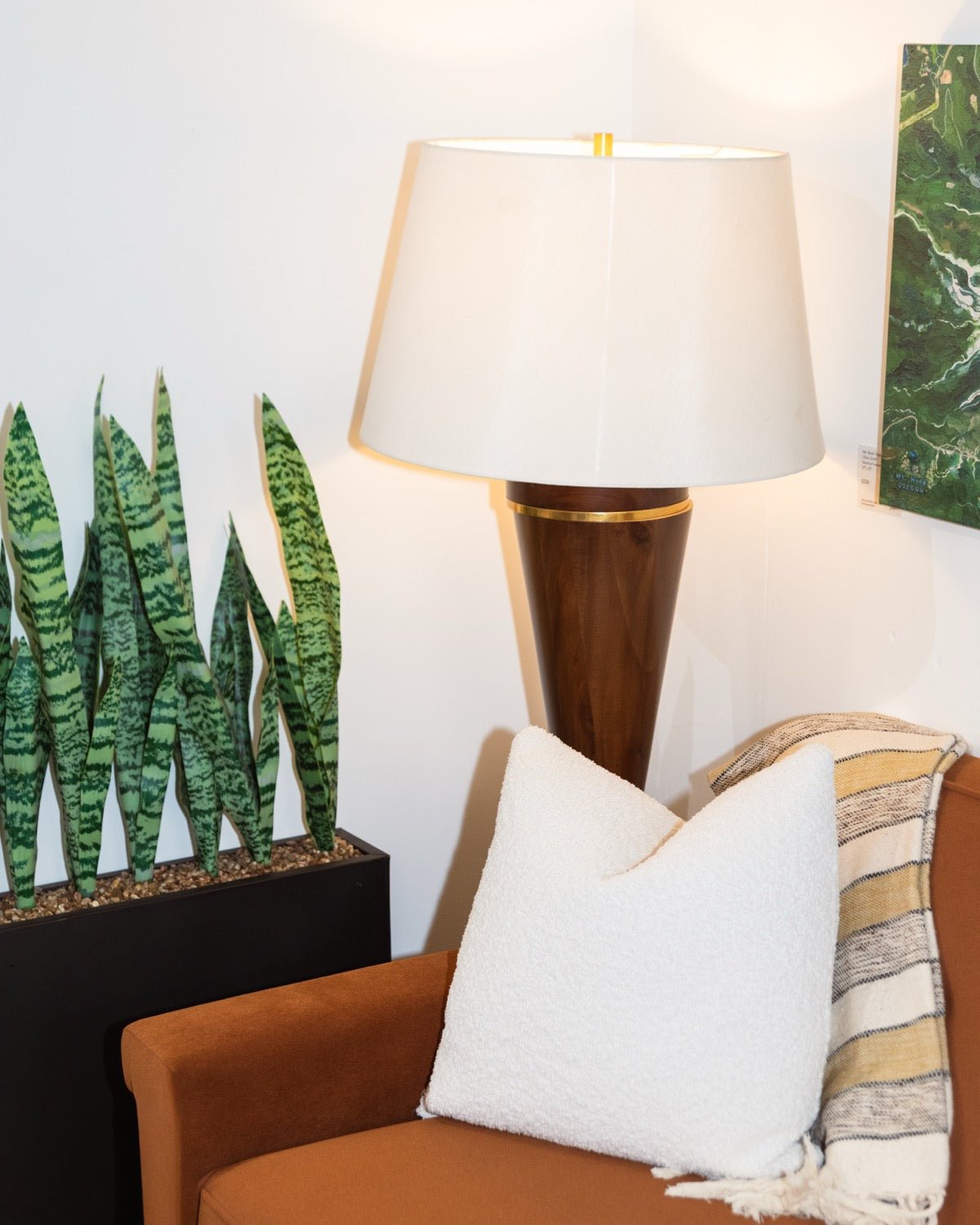 Styled reading corner with lamp, plant, and accent chair